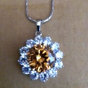 14 CZ Diamonds surround a large orange/brown stone pendant/necklace